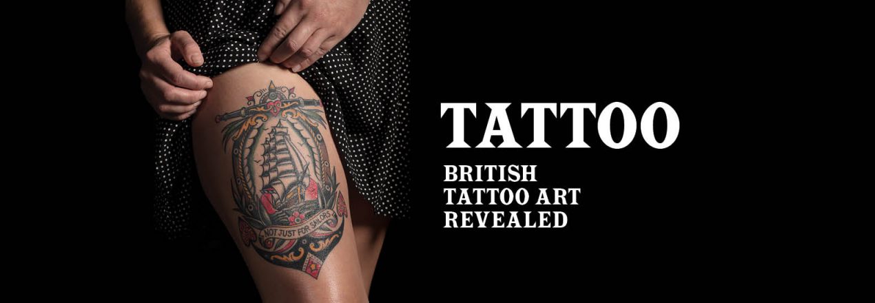 A promotional image for 'Tattoo: British Tattoo Art Revealed'. On the left-hand side, a woman shows a tattoo on her thigh. On the right is the exhibition's name.