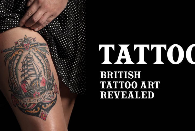 A promotional image for 'Tattoo: British Tattoo Art Revealed'. On the left-hand side, a woman shows a tattoo on her thigh. On the right is the exhibition's name.