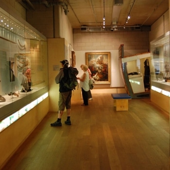 A photo of the Museum's Falmouth Gallery, with two visitors looking at the displays.