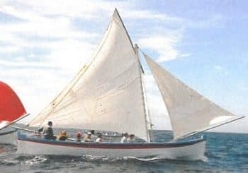 A photo of seven people sailing onboard the 'Carlisle'.