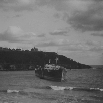 A black and white photo of the 'Kirkpool' foundered on Castle Beach in Falmouth.
