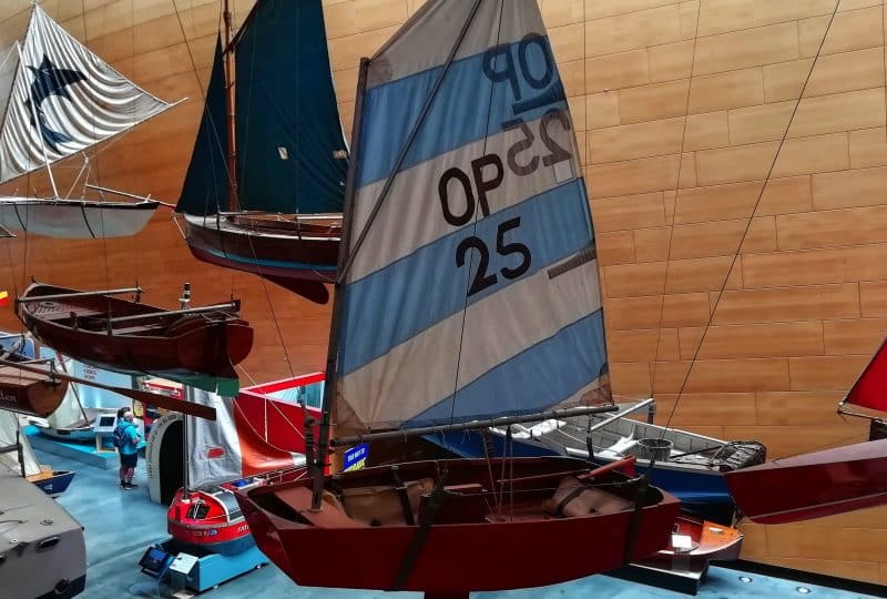 Photo of the 'International Optimist' hanging from the ceiling in the Museum's Boat Hall.