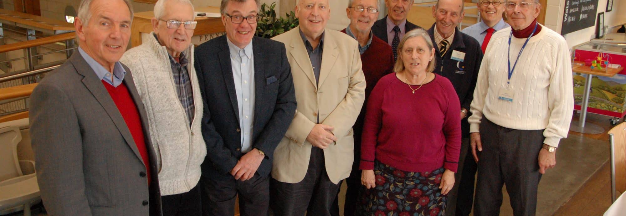 Nine volunteers celebrate reaching five or ten years of voluntary service, pictured with the Museum's director Richard Doughty.