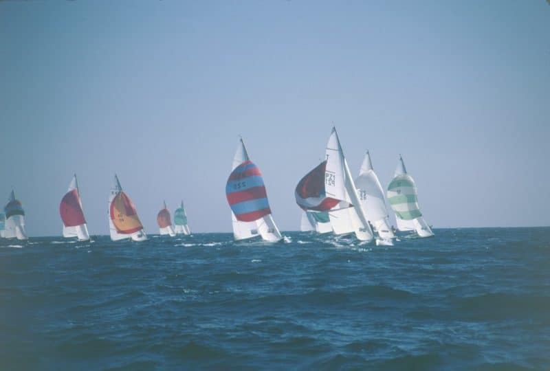 A photo of nine Tempest boats taking part in a race.