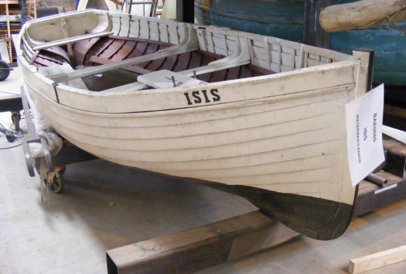 Photo of the 'Isis' with a sign attached to the front that reads 'ISIS Waterman's Barge'.