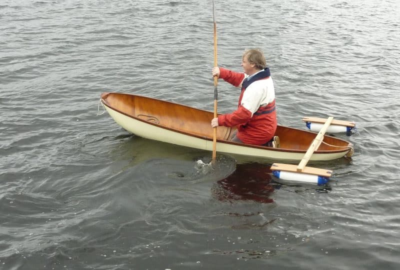 A photo of a man paddling in the 'Pixie'.