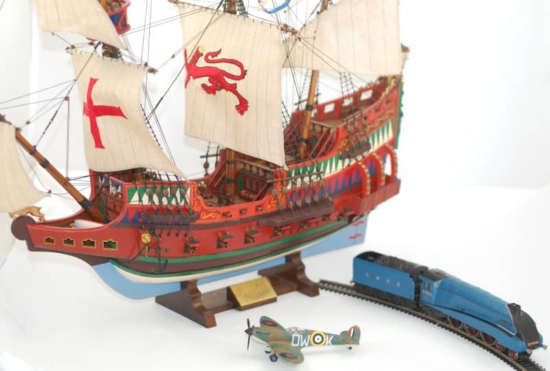 Photo of a model ship, with a model of the Mallard locomotive to one side.