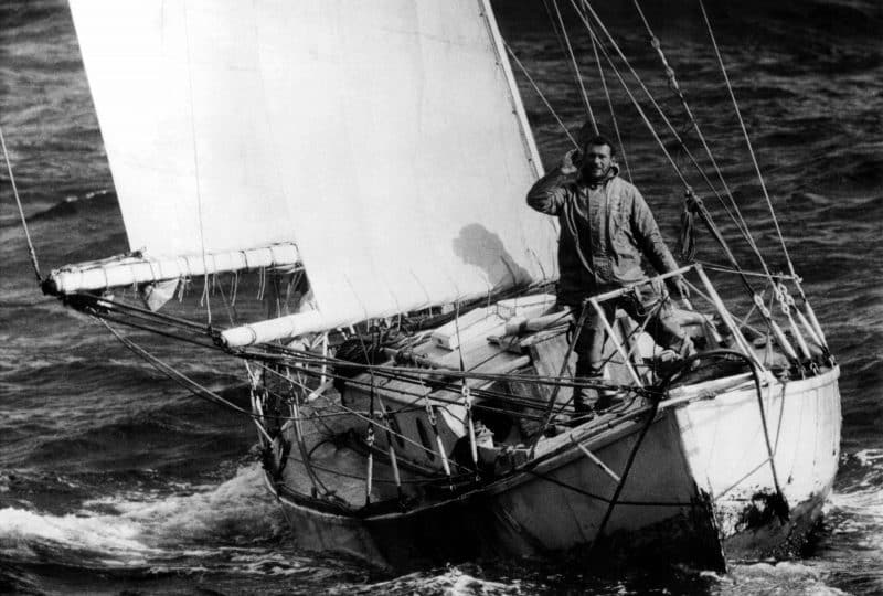 A black and white photo of Sir Robin Knox Johnston onboard his vessel.