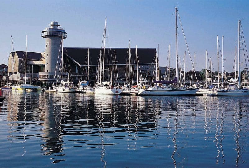 Photo of the Museum from across the harbour with the marina in front of it.