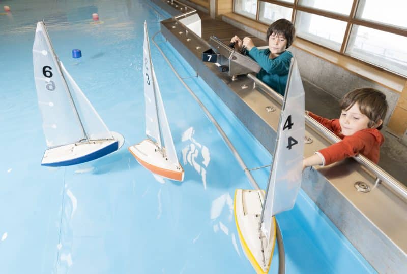 Two young children play using the Museum's Boat Pool.