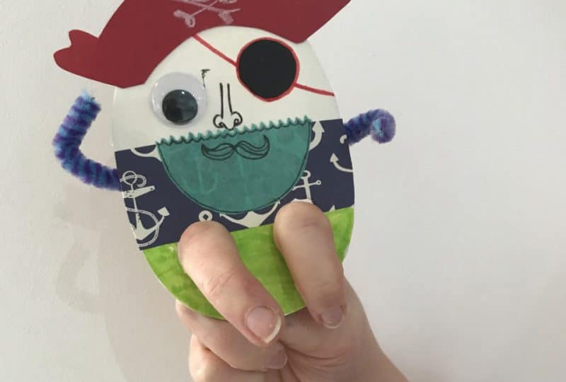 Photo of a pirate finger puppet made from card, fabric, pipe cleaners and googly eyes.