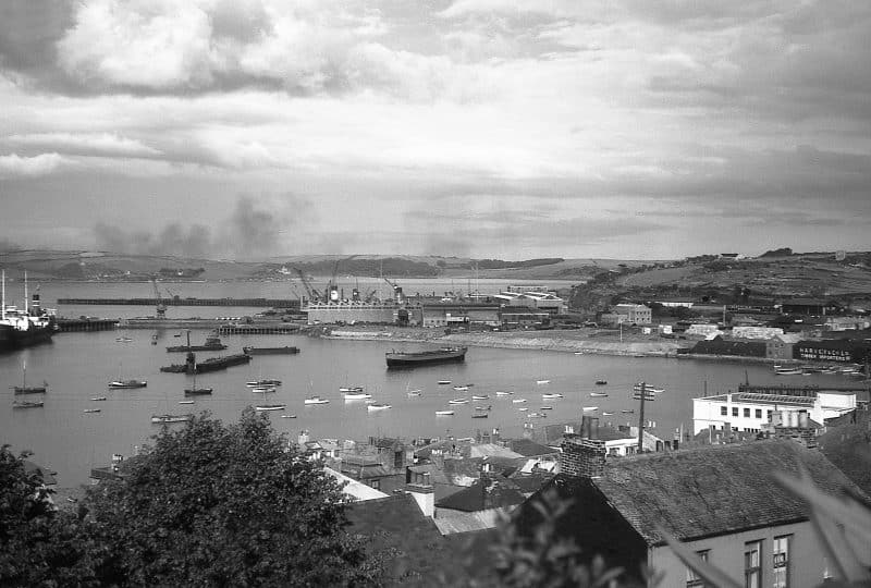 Black and white photo across part of Falmouth harbour over to the Docks.