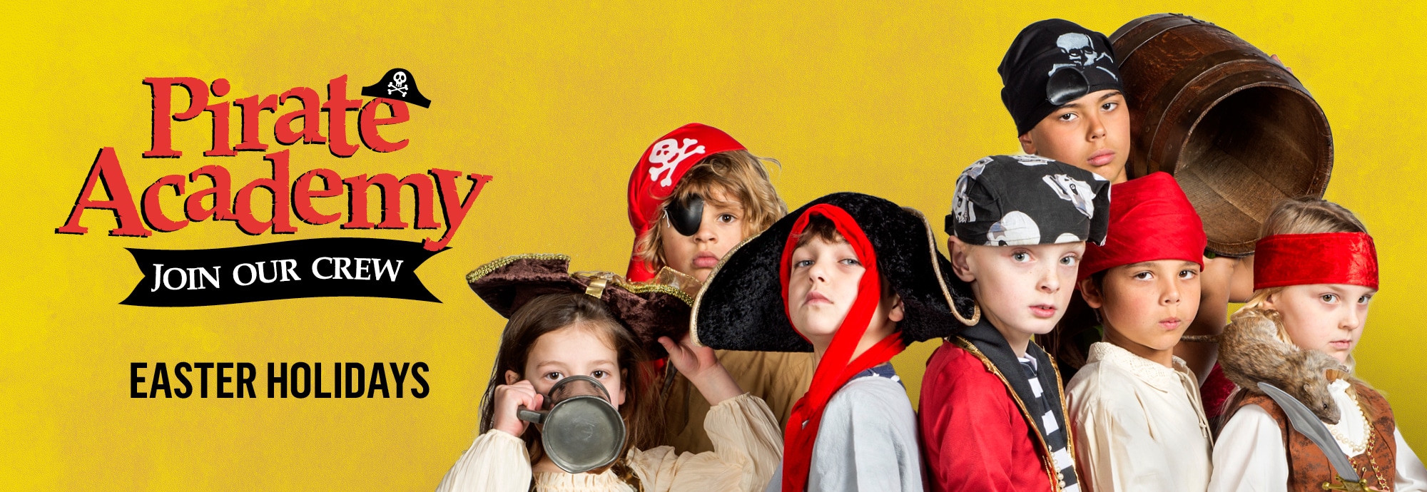 The left side of the image features text that reads 'Pirate Academy', 'join our crew' and 'Easter holidays'. On the right, seven children are dressed in pirate costumes.
