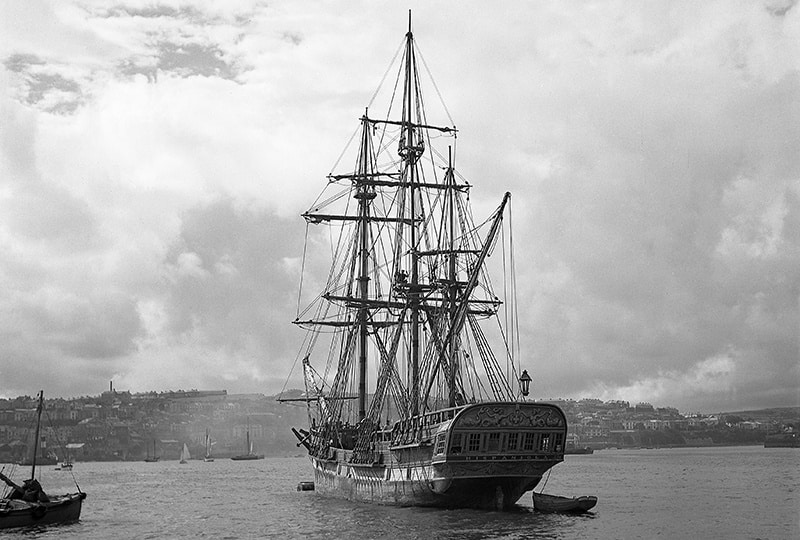 Black and white image of the Hispaniola with Falmouth town in the background.