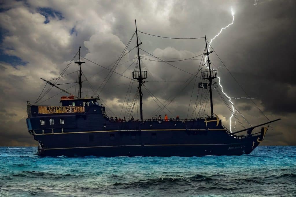 A ship sails through a storm, with a bolt of lightning striking the water in the background.