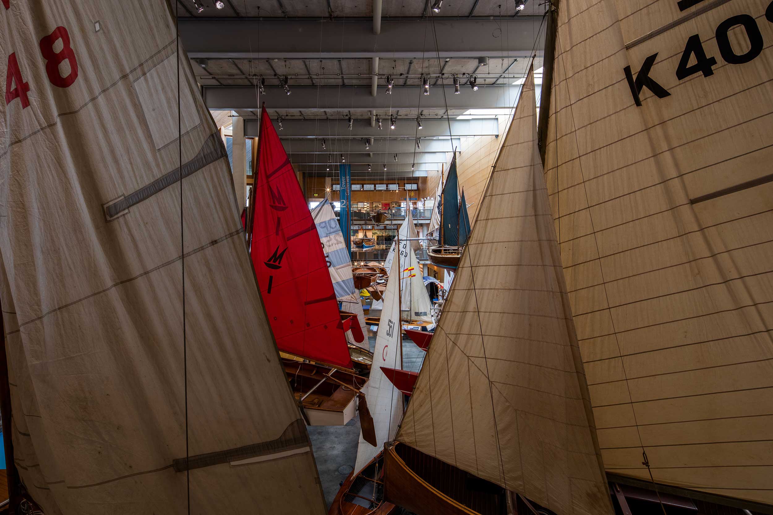 Photo of the boats hanging from the ceiling of the Main Hall at National Maritime Museum Cornwall.