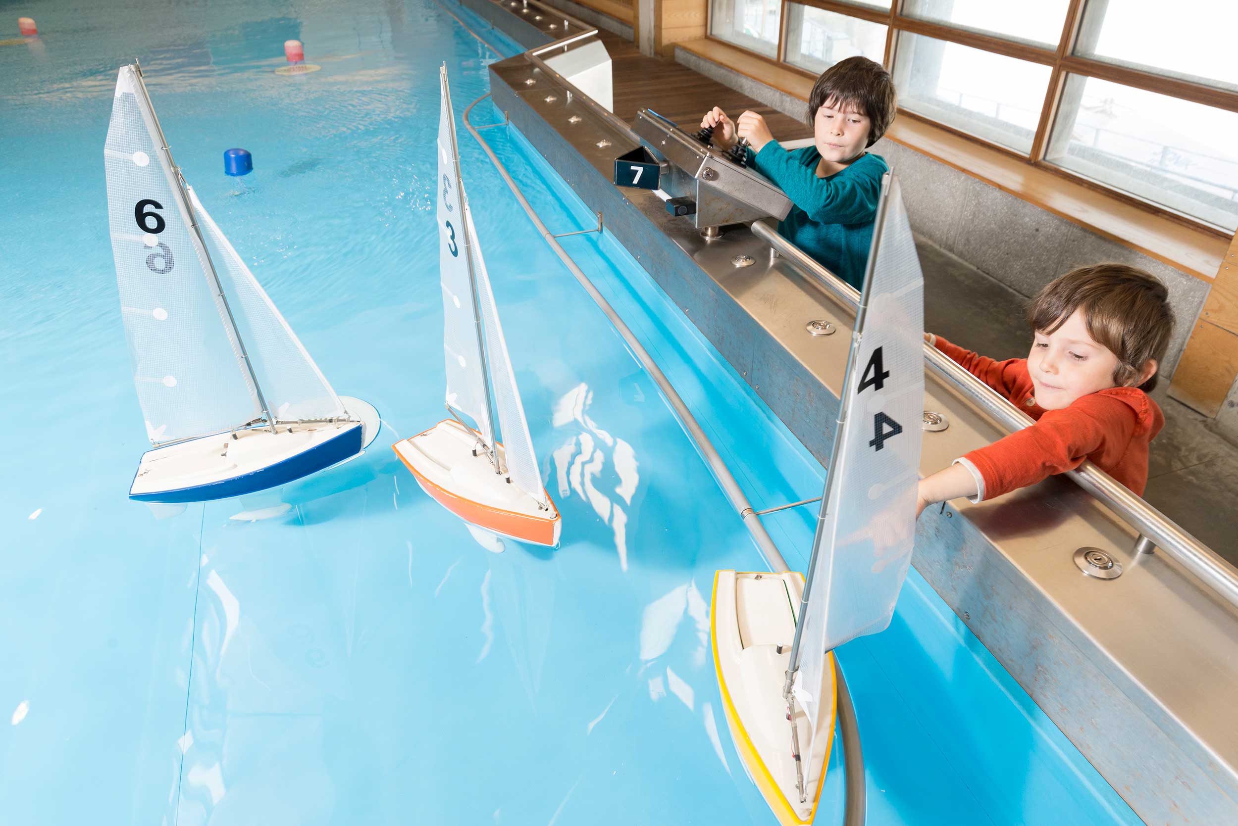 Two young children play using the Museum's Boat Pool.