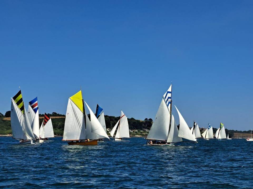 A photo of the racing fleet sailing on the Carrick Roads. Pictured on a sunny day.