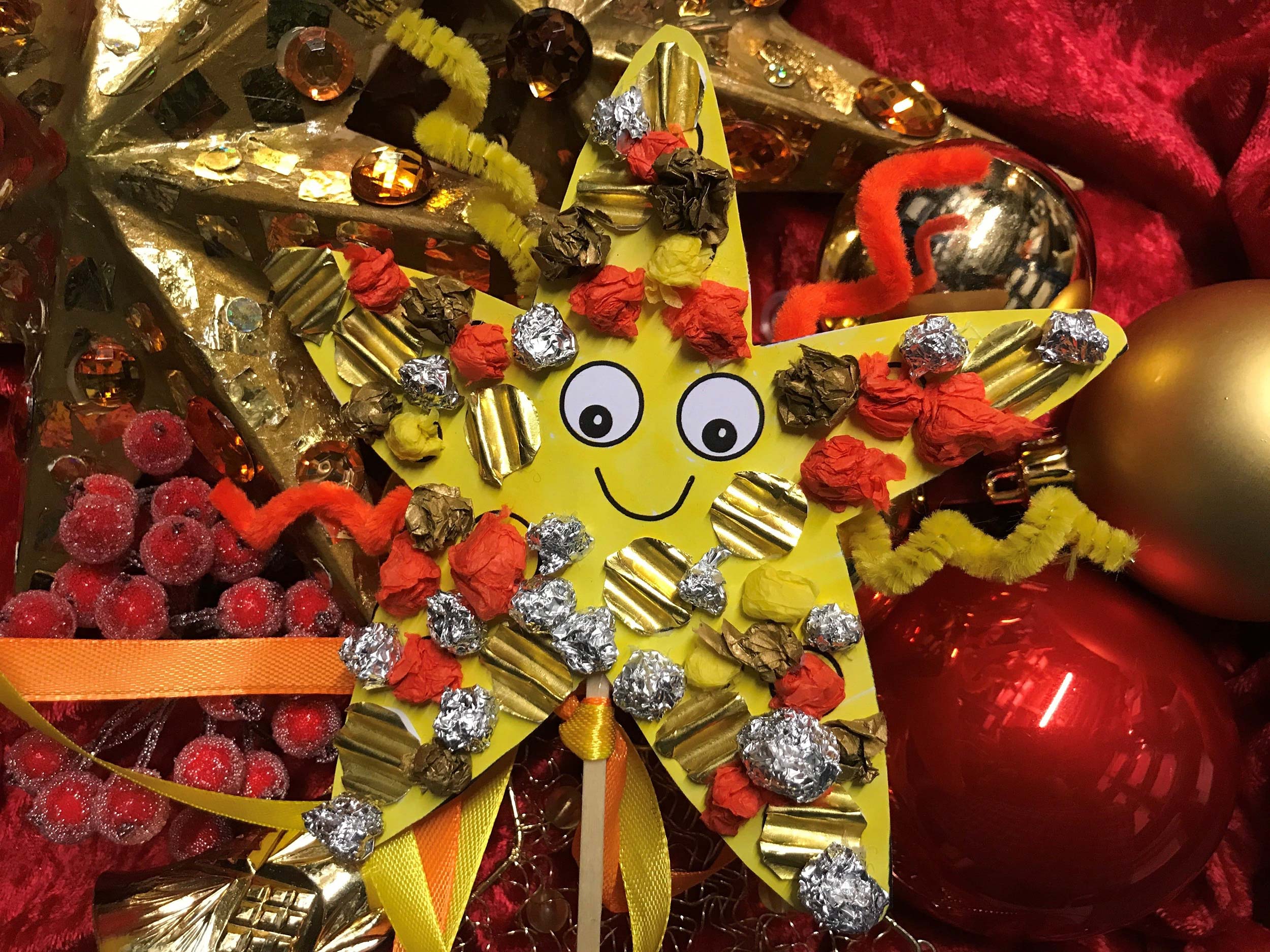 A Christmas-themed starfish decorated using tinfoil and tissue paper.