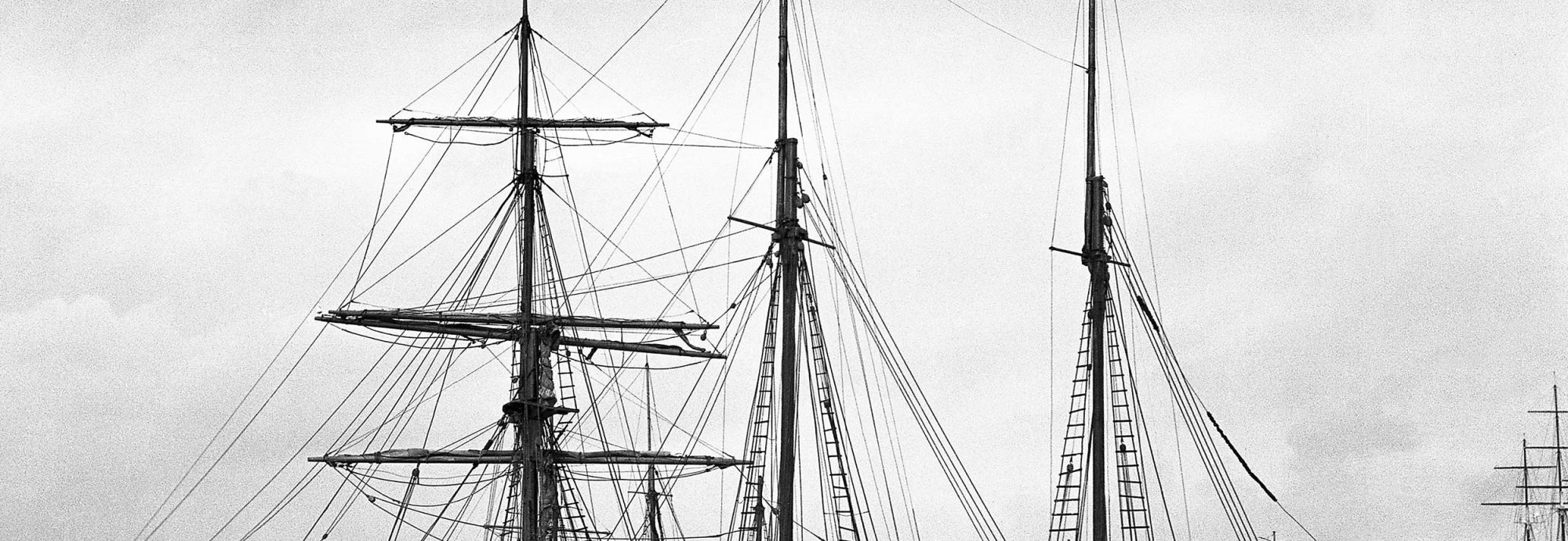 Black and white photo of the barquentine 'Waterwitch' in Falmouth harbour.