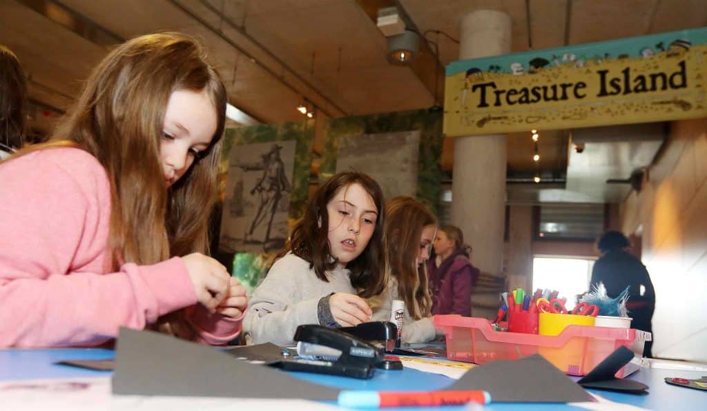 Two young girls take part in craft activities in the Museum.