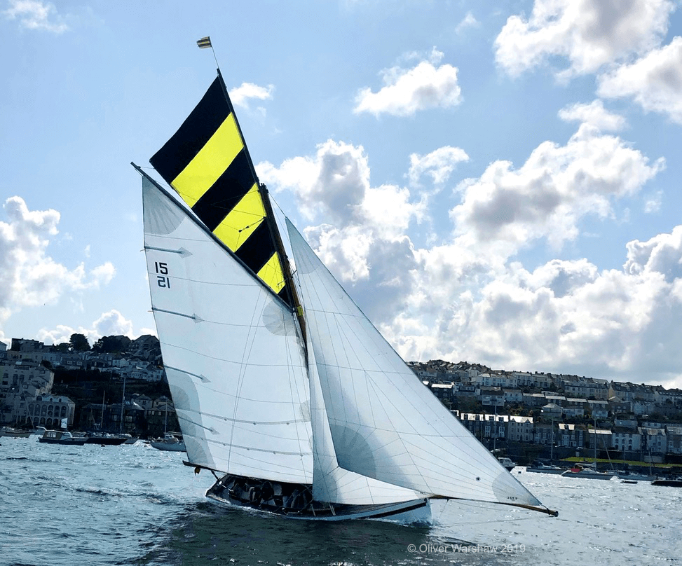 A photo of the boat Evelyn with racing topsail in Falmouth Harbour, taken in 2019.