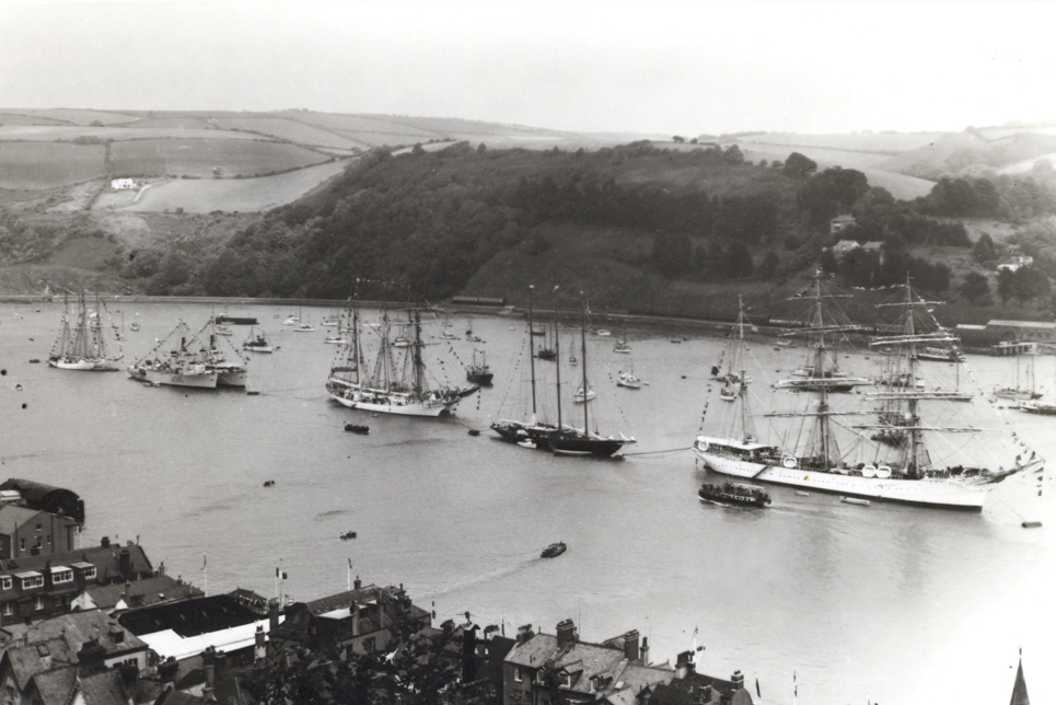 A black and white photo of Tall Ships moored in the River Dart, taken in July 1956 before the first Tall Ships race from Torbay to Lisbon.