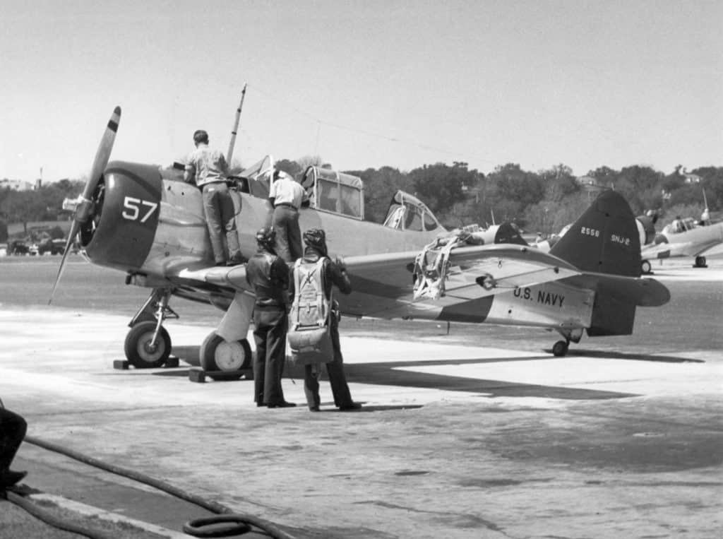 A black and white photo of an SNJ-2 Aircraft prepared for a training flight at Pensacola in 1942.