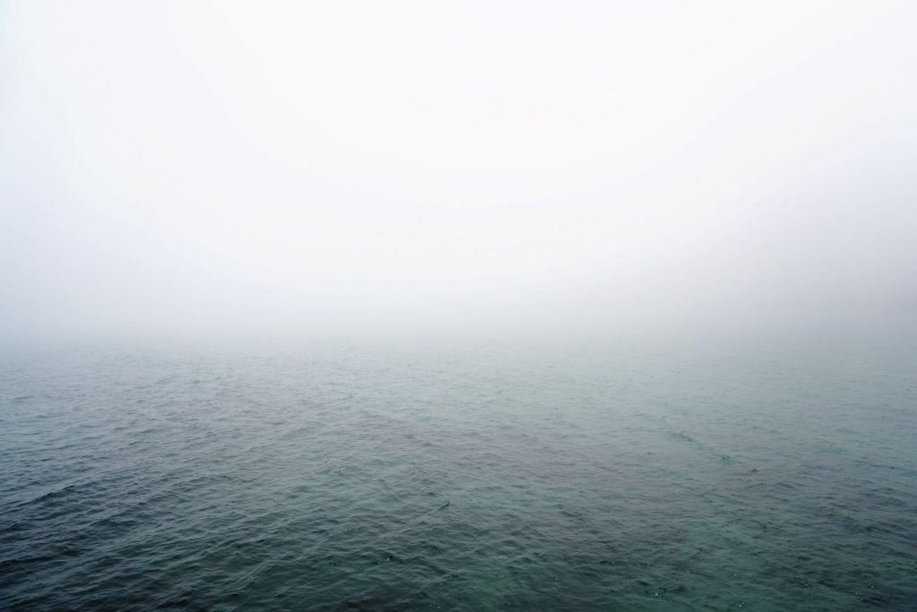 A photo of the ocean covered in mist.