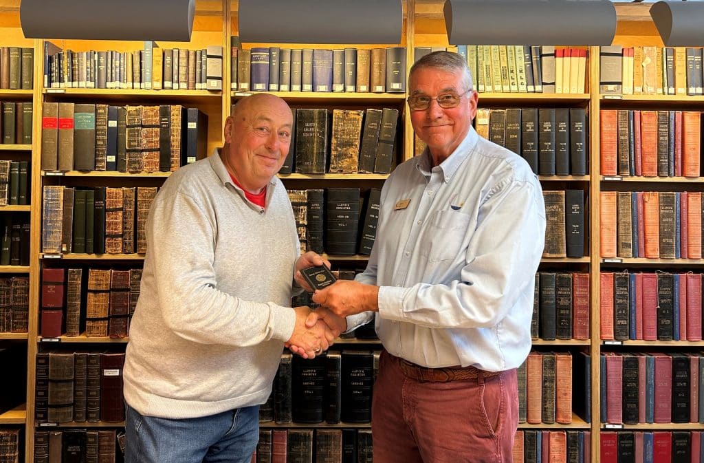 A photo of Paul Dowman receiving the wallet from Simon Turner in the Bartlett Maritime Research Centre and Library of National Maritime Museum Cornwall.