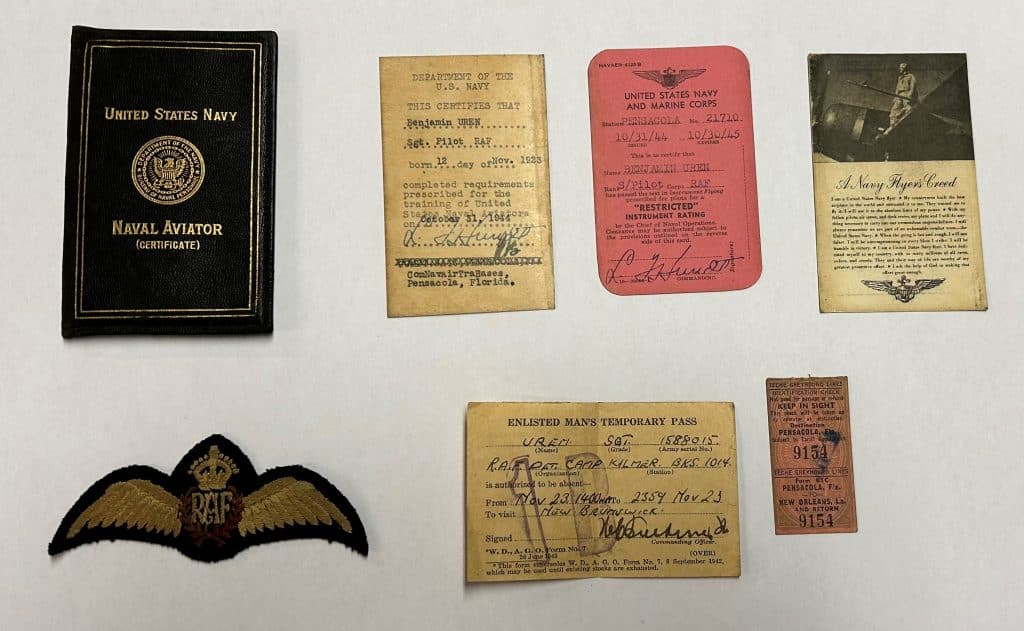 A photo of the Wallet, the RAF ‘Wings’ and Contents on a white table.