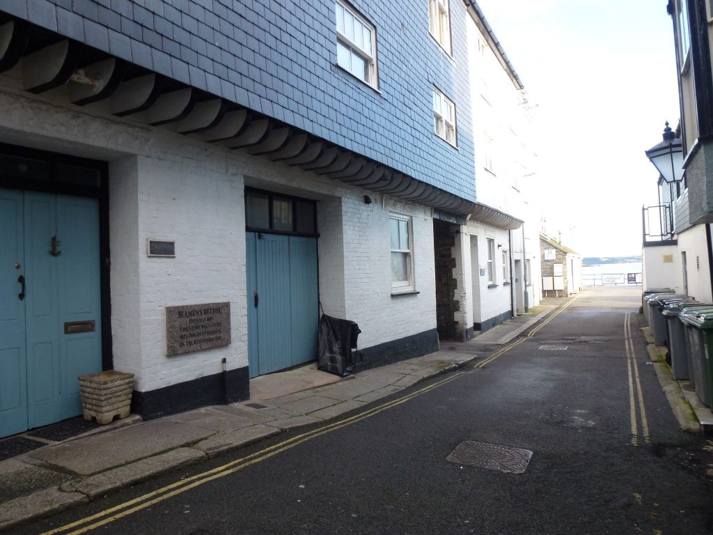 A photo of the site of The Seamen’s Bethel Plaque, Quay Hill, Falmouth. The road leads out to the water's edge.