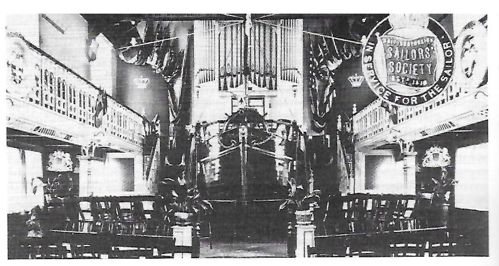 This photograph shows the unique ship’s bow pulpit for which the Bethel was best known, fitted with port and starboard lights, and dedicated to the memory of King Edward VII. The pulpit hides the bellows of the organ.