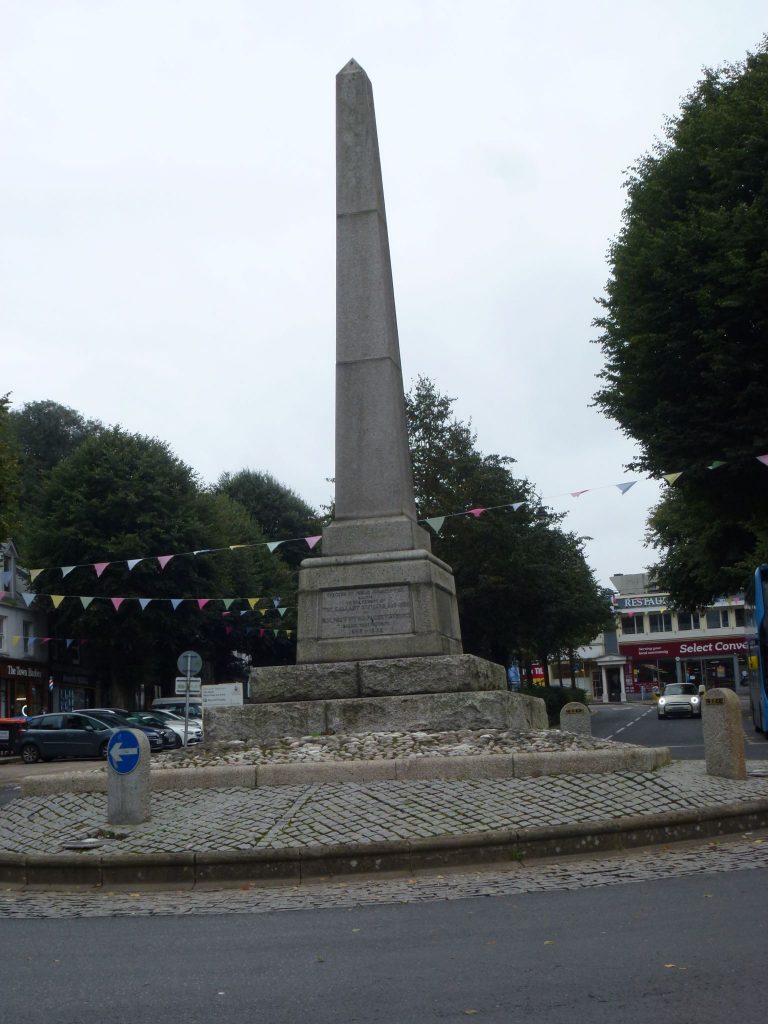 A photo of The Packet Memorial on The Moor, Falmouth. It's an obelisk stood on a roundabout.