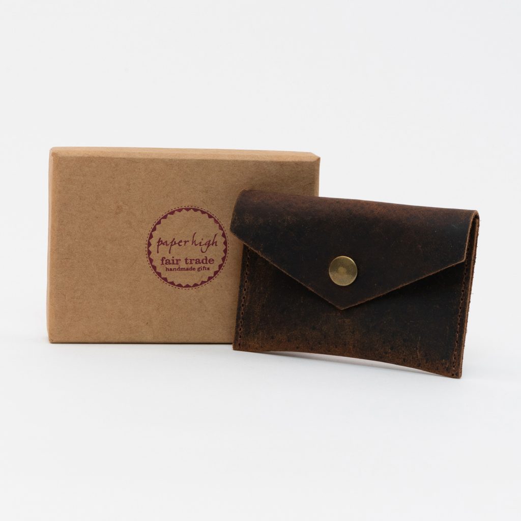 Dark brown leather coin pouch with brass popper alongside the tan box.
