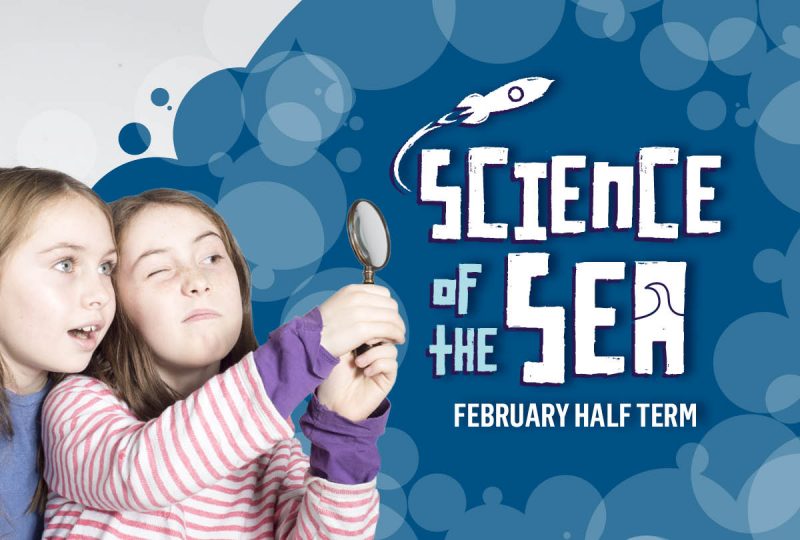 Science of the Sea at National Maritime Museum Cornwall. Two girls looking through a magnifying glass.