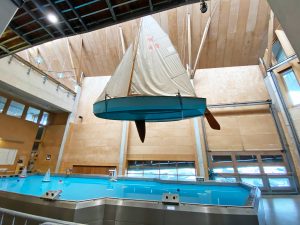 A view of Wanderer hanging above the Boat Pool after Phase One of National Maritime Museum Cornwall's Main Hall Re-rig.