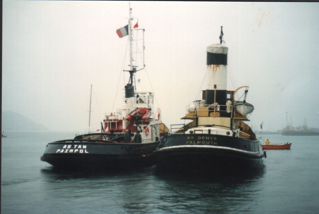 Falmouth tug St Denys leaving Custom House Quay with French tug Astan, on its journey to the Maritime Museum at Douarnenez in Brittany in 1991.