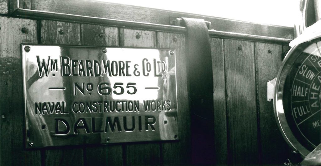 A black and white photo of the maker’s nameplate.