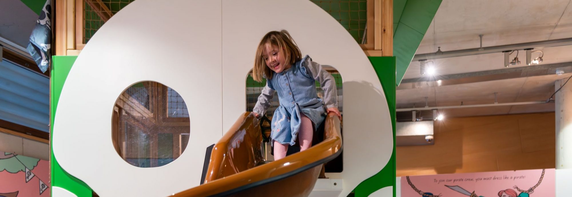 A young girl playing in the Skull Island Play Zone at National Maritime Museum Cornwall.