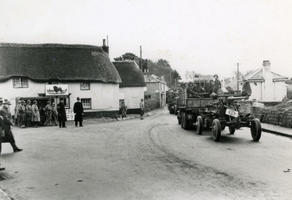 American troops driving through the village of Mawnan Smith to Polgwidden (Trebah Beach) on the Helford ready for Operation Duck, one of the many rehearsals, passing the Red Lion pub.