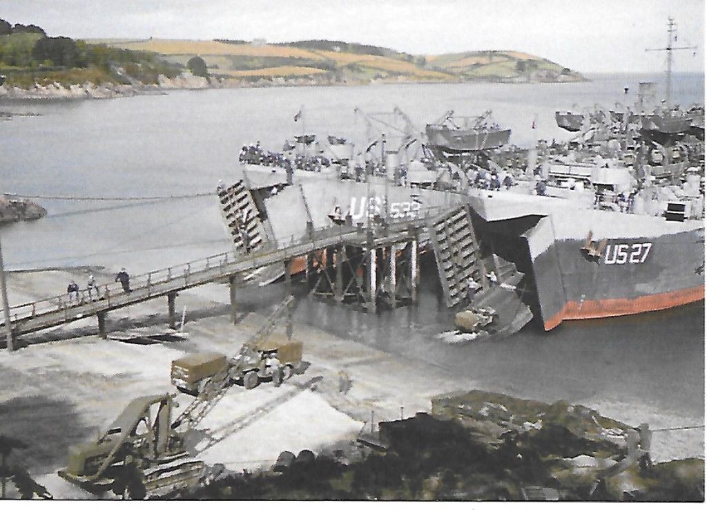 A Trebah Gardens postcard of a photograph showing loading of the LSTs, colourised by Joshua Barrett from ‘Painting the Past’.