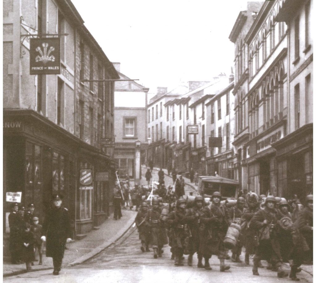US Troops march along Falmouth’s Webber Street and Market Strand to embark at Prince of Wales Pier for Operation Duck 1 on 30 December 1943, one of the many dress rehearsals for D-Day.
