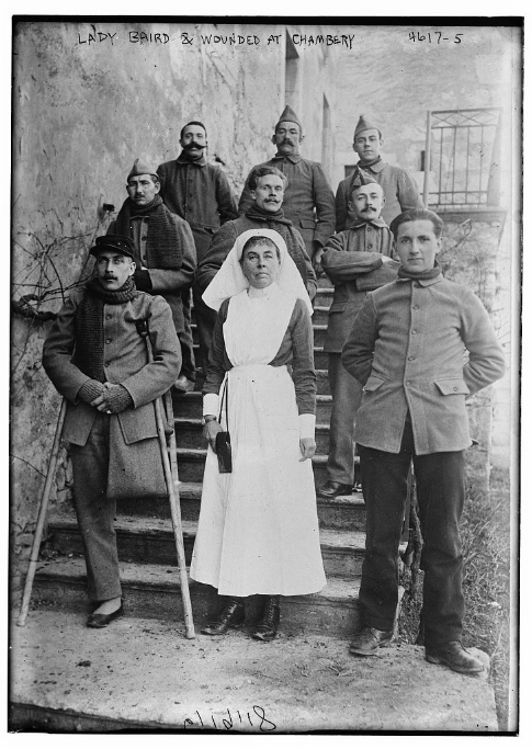 A black and white photo of Constance in 1918 with wounded Belgian soldiers at Chambery Hopital Militaire Belge