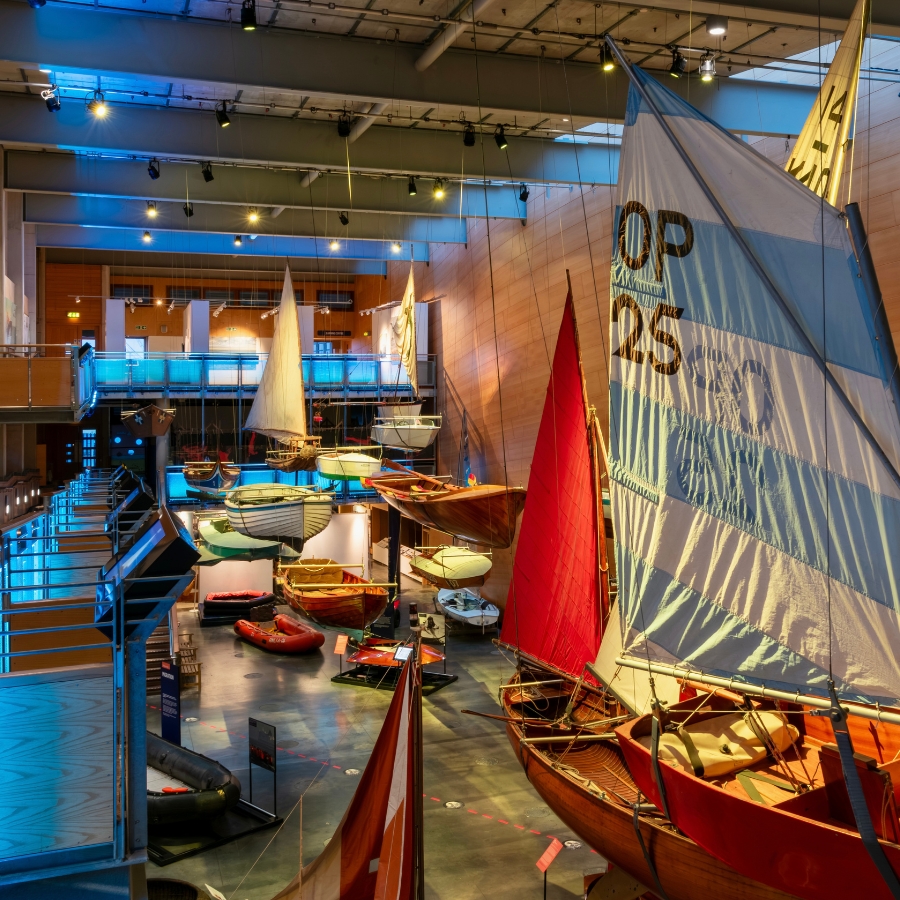 The Flying Flotilla at National Maritime Museum Cornwall. Boats hang from the ceiling in the Boat Hall.