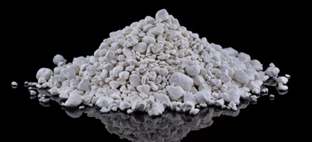 A pile of crushed china clay on a black background.