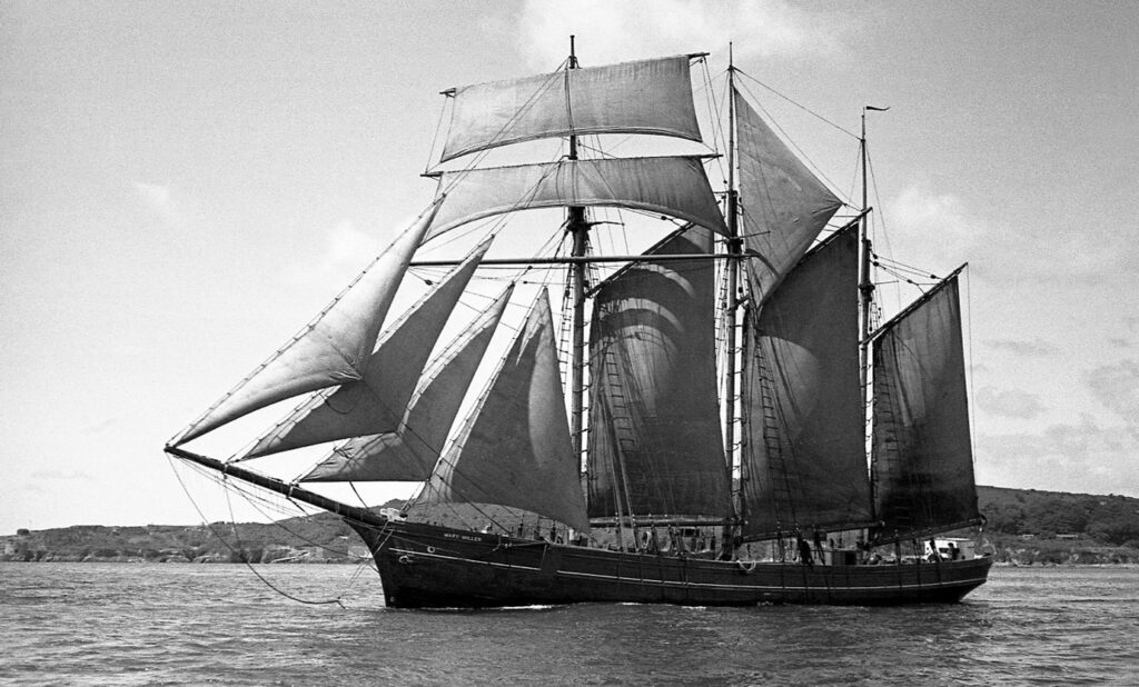 A black and white photo of the three masted topsail schooner Mary Miller off Falmouth in 1938.