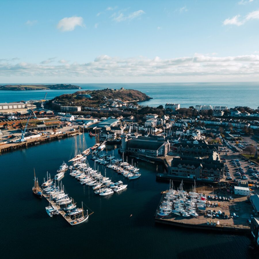 An aerial shot of NMMC and Falmouth Harbour on a blue-sky day.