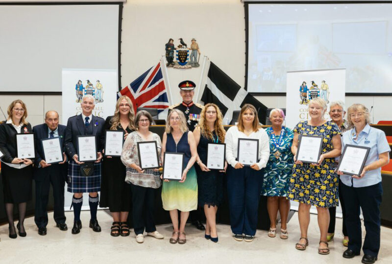 A group photo of all of nominees for the Kings Award for Voluntary Service holding their certificate.