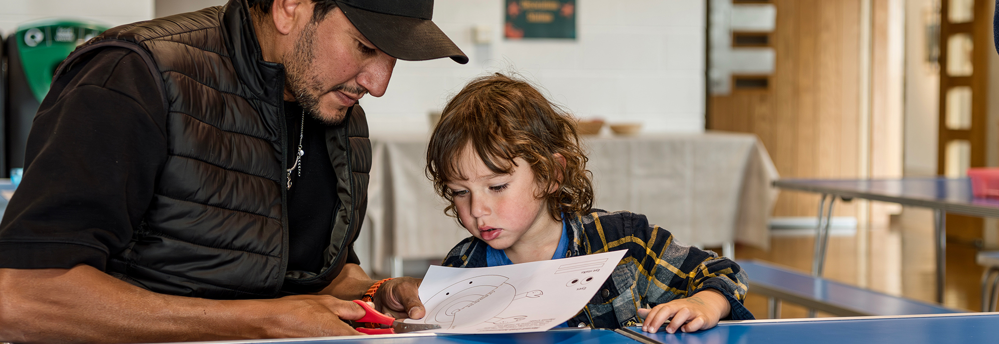 A photo of a man and a child taking part in Make and Take.